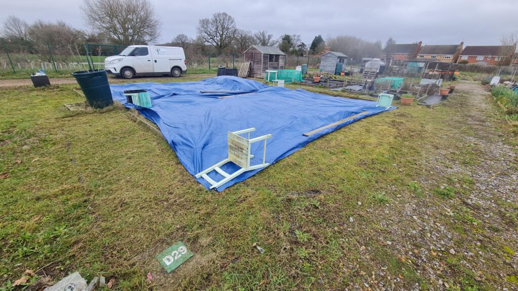 allotment plot at deardon with tarpaulin over to stop weeds growing ehilst its reallocated
